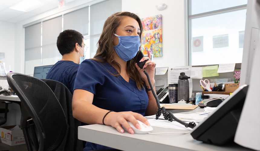 receptionist taking patient calls from culebra creek veterinary hospital and resort